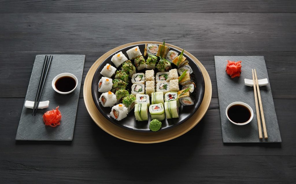 set-of-sushi-maki-and-rolls-at-black-rustic-wood-P9ARWRU-min